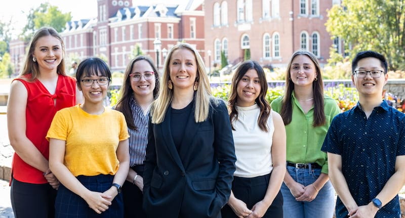 The Boychuk Lab group. Seven employees of Dr. Boychuk lab with a backdrop of the Beautiful Mizzou campus in the back.